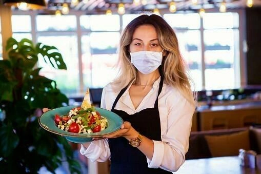 Happy waitress working at a restaurant, COVID - 19 Concept.